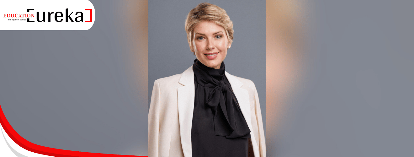 Irina Willems professional headshot in a cream blazer and black blouse, poised and confident