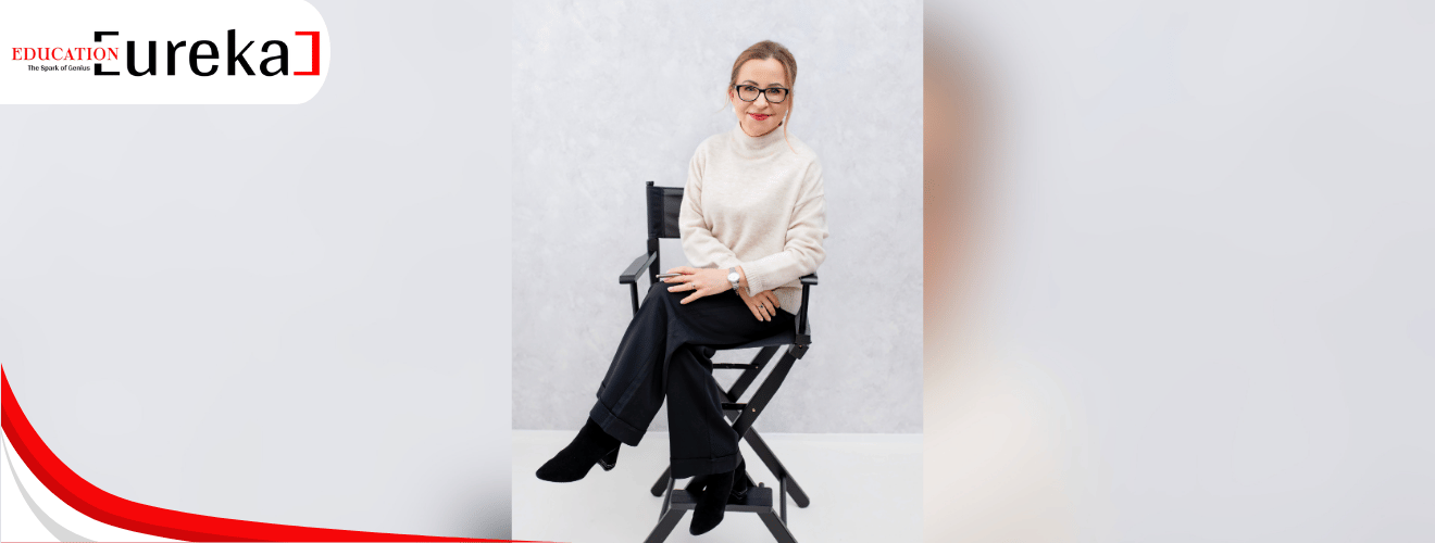Izabela Kramarz seated on a director’s chair in a minimal studio